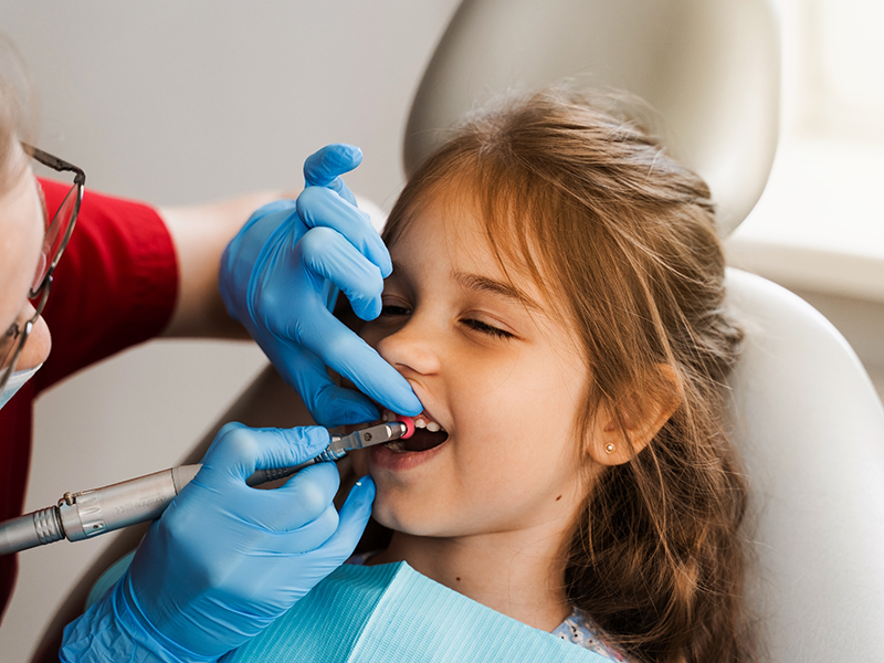 Young girl getting a dental cleaning