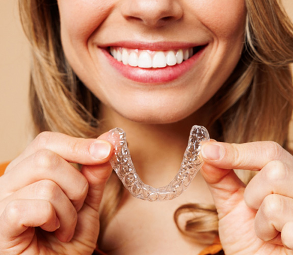 A young woman preparing to use clear aligners