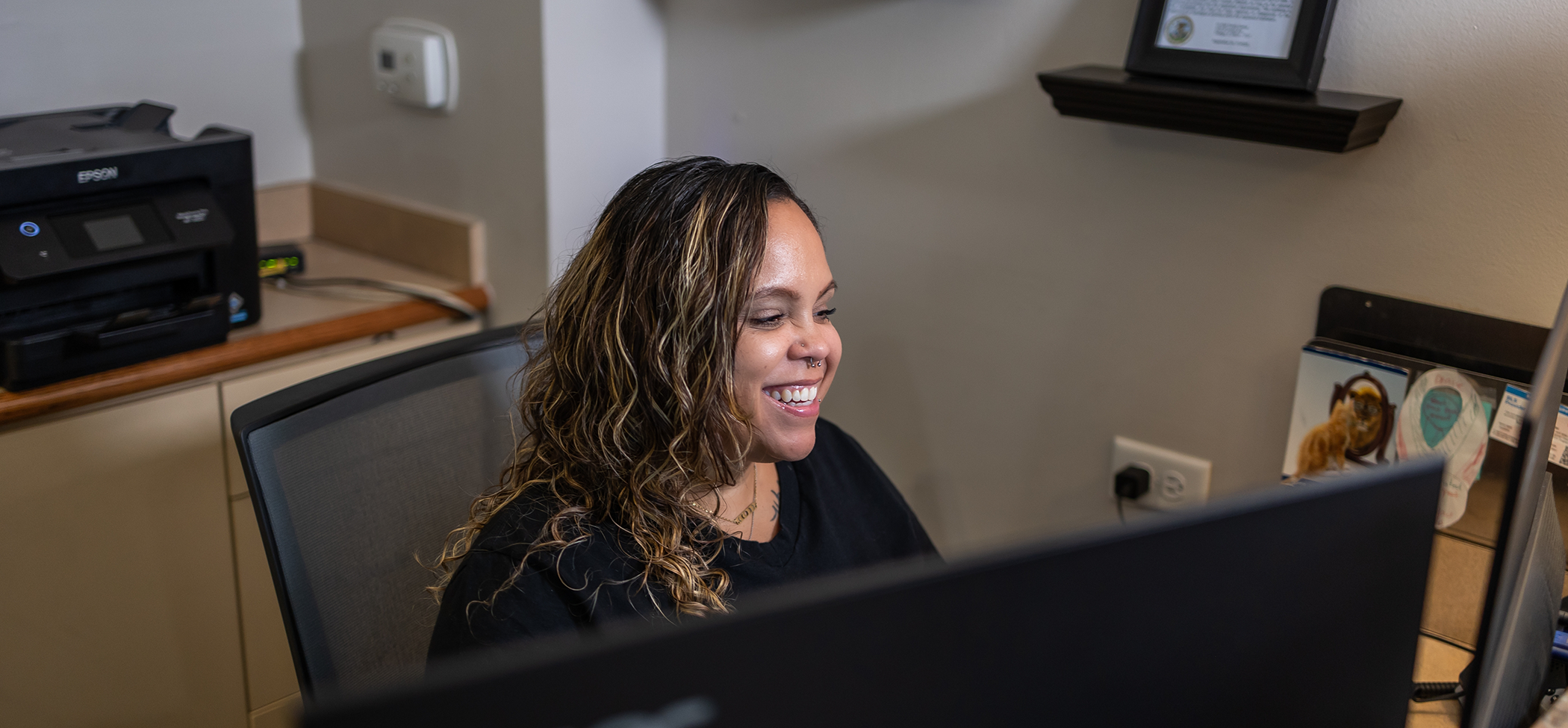 Dental team member smiling at the front desk