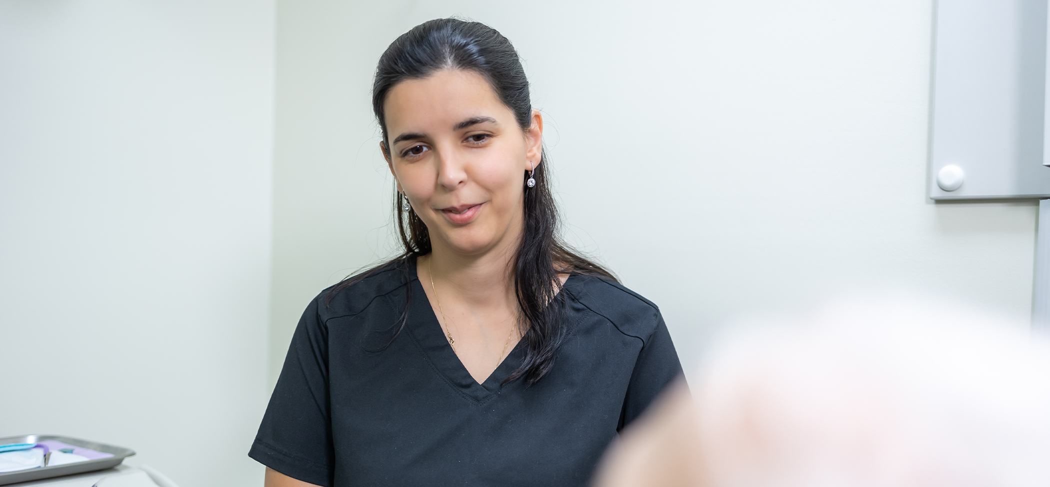 Dental team member talking to a patient about replacing missing teeth