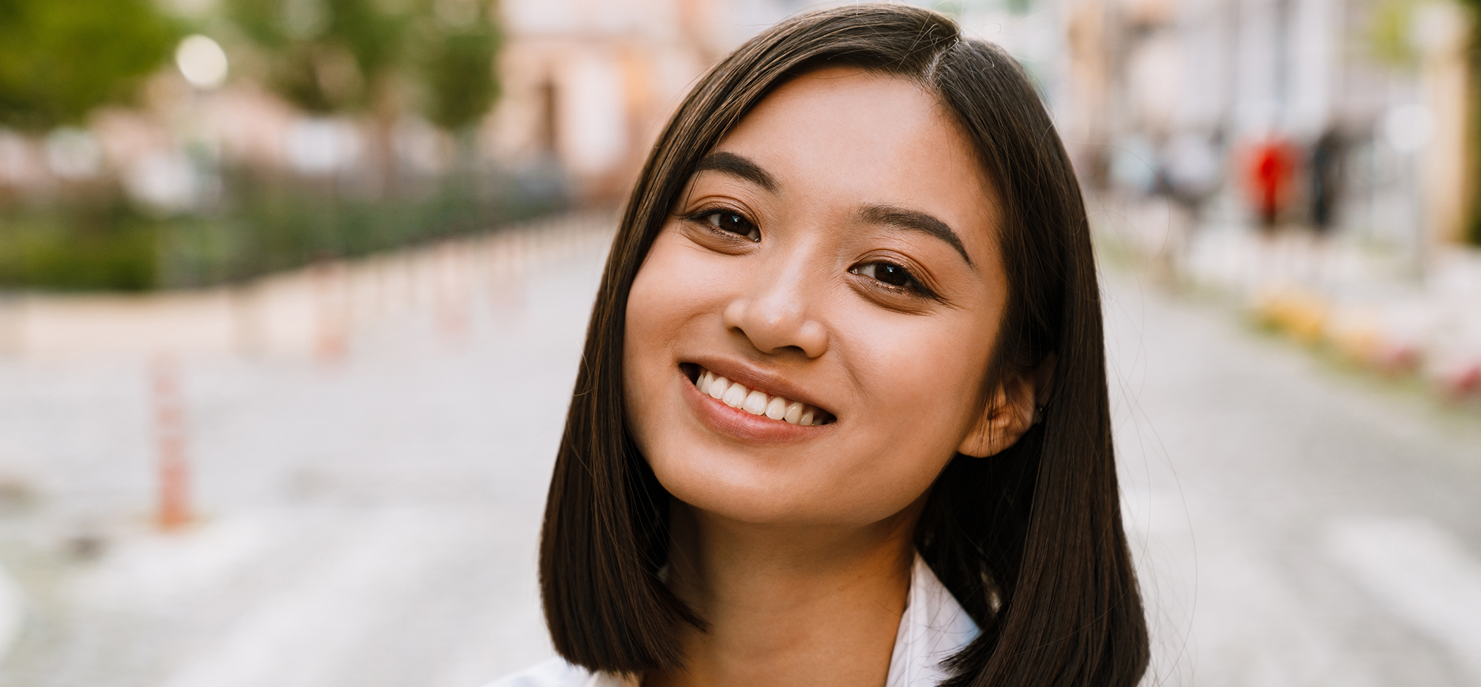 Woman smiling with perfectly straight teeth after orthodontics in Lincoln Park