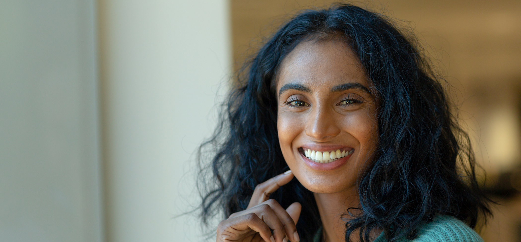 Woman with wavy black hair smiling