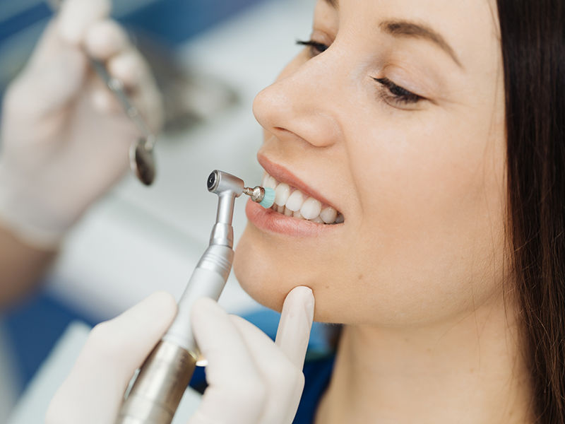 Dental patient getting her teeth professionally cleaned