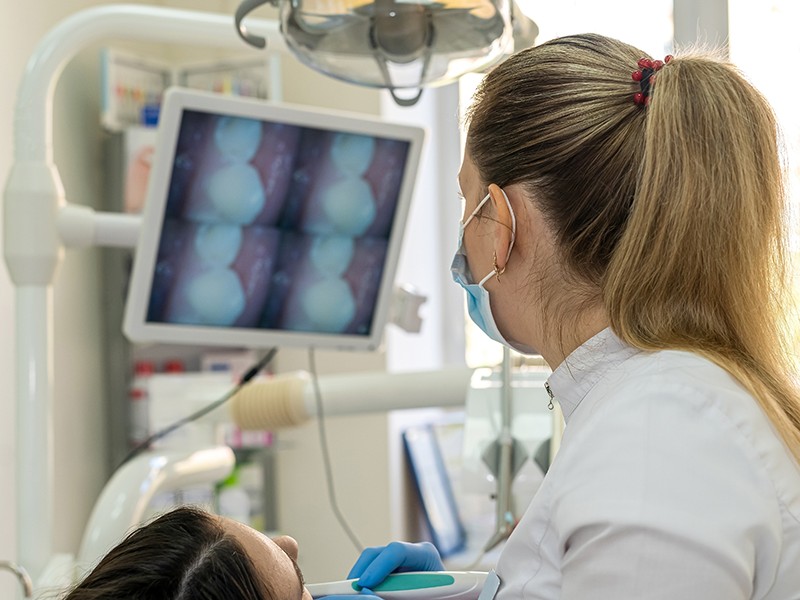 Dentist taking close up photos of a patient's teeth