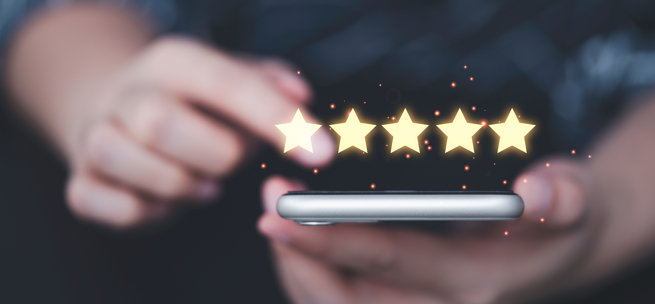 Person leaving a five star review on their phone